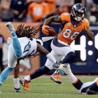 Broncos receiver Demaryius Thomas runs away from Panthers safety Tre Boston on Thursday in Denver. Broncos beat Panthers in rematch of Super Bowl 50