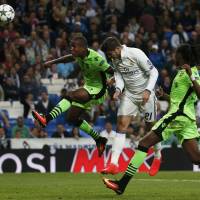Real Madrid's Alvaro Morata scores the go-ahead goal in injury time against Sporting Lisbon in a Champions League group-stage match on Wednesday in Madrid. Real triumphed over Sporting 2-1. Late drama lifts Real Madrid