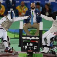 France’s Damien Tokatlian (left) competes against Hong Kong’s Tam Chik Sum during the men’s foil team bronze medal match at the 2016 Rio Paralympics on Friday in Rio de Janeiro. Wheelchair fencers exhibit unique skills