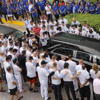 Miami Marlins players see off the hearse carrying the body of pitcher Jose Fernandez as it leaves Marlins Park on Wednesday. Fernandez was killed in a boating accident Sunday. Marlins bid emotional farewell to Fernandez