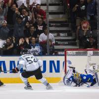 Team North America's Nathan MacKinnon (left) celebrates his game-winning goal with teammate Shayne Gostisbehere against Sweden's goalie Henrik Lundqvist in overtime of their World Cup of Hockey game in Toronto on Wednesday. North America beats Sweden in OT, needs help to advance