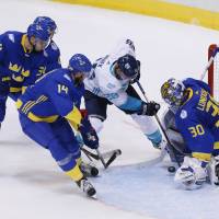 Team Europe's Thomas Vanek (center) tries to score past Sweden goalie Henrik Lundqvist on Sunday in Toronto. Team Europe bounces Sweden from tourney
