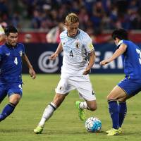 Keisuke Honda takes on the Thailand defense during Japan's 2-0 win at Bangkok's Rajamangala Stadium on Tuesday night in a World Cup qualifier. Japan earns crucial breathing space with win over Thailand