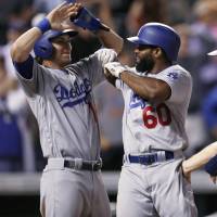 Los Angeles' Andrew Toles (center) is congratulated by teammates after his grand slam in the top of the ninth against Colorado on Wednesday night. The Dodgers took the second game of a doubleheader 10-8 after losing the opener 7-0. Dodgers' Toles slugs winning slam in 9th
