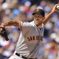 Giants starter Madison Bumgarner pitches against the Cubs on Saturday afternoon in Chicago. Giants' Bumgarner outduels Cubs' Arrieta