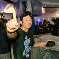 Cubs infielder Munenori Kawasaki celebrates the team's division title in the clubhouse after Chicago's win over Milwaukee on Friday. The Cubs are the first MLB team to clinch a division title this season. Cubs celebrate division title by beating Brewers