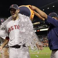 Red Sox pitcher Rick Porcello is doused with water after winning his 21st game of the season on Monday in Baltimore. Porcello holds down Orioles for 21st win
