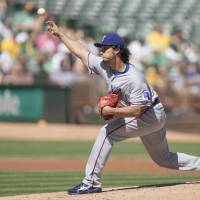 The Rangers’ Yu Darvish pitches against the A’s on Saturday in Oakland. The AL West champions beat the A’s 5-0. Darvish, Andrus lead Rangers to victory