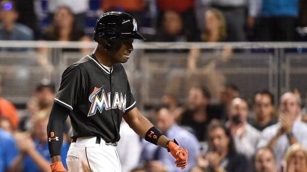 Miami's Dee Gordon weeps as he returns to the dugout after hitting a solo home run in the first inning against New York on Monday night. The Marlins beat the Mets 7-3. Marlins win one for Fernandez