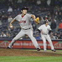 Boston's Koji Uehara pitches against New York in the eighth inning on Wednesday night. The Yankees beat the Red Sox 5-3. Red Sox wrap up AL East division crown