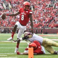Louisville QB Lamar Jackson (8) evades a tackle during Saturday's win over Florida State. Jackson stars as Louisville routs Florida State