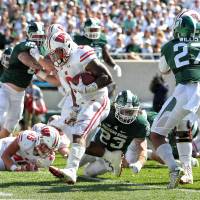 Badgers running back Corey Clement scores a touchdown on Saturday. No. 11 Wisconsin demolishes No. 8 Michigan St.