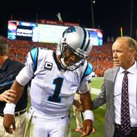 The Panthers' Cam Newton is aided by team staff after an injury during the third quarter against the Broncos on Thursday in Denver. Rivera wants Newton protected