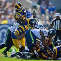 Rams running back Todd Gurley dives over the pile during the second half of the his team's game against the Seahawks on Sunday in Los Angeles. The Rams won 9-3. Rams win in long-awaited return to L.A.