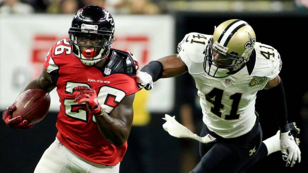 Atlanta's Tevin Coleman runs with the ball as New Orleans' Roman Harper tries to tackle him in the first quarter on Monday night. The Falcons outscored the Saints 45-32. Freeman, Coleman lead Falcons in rout