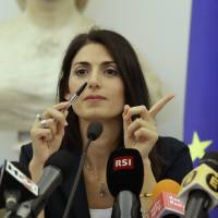 Rome Mayor Virginia Raggi gestures during a press conference after she did not show up at a scheduled meeting with a delegation of the Italian Olympic Committee in Rome Wednesday. Raggi says it's irresponsible to bid for 2024 Olympics, effectively dooming Rome's candidacy. Mayor Raggi rejects Rome's 2024 Olympics bid, draws flak