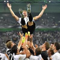 Germany captain Bastian Schweinsteiger is given a doage by teammates after his final game with the national team on Wednesday night. Germany beat Finland 2-0. Schweinsteiger bows out in Germany's victory over Finland