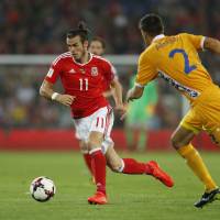 Wales star Gareth Bale moves the ball against Moldova in their World Cup qualifer in Cardiff on Monday. Wales won 4-0. Spain, Wales dominate; Kosovo gets first point