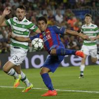 Barcelona's Luis Suarez scores his team's sixth goal in Tuesday's 7-0 Champions League group-stage win over Celtic at the Nou Camp. Barcelona thrashes Celtic in Champions League opener