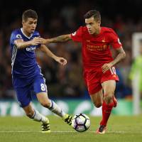 Liverpool's Philippe Coutinho moves the ball while being defended by Chelsea's Oscar during their match on Friday at Stamford Bridge in London. Liverpool too much for Chelsea