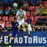 Japan's Hiroki Sakai (right) vies with Thailand's Kroekrit Thawikan during their 2018 World Cup qualifying match in Bangkok on Tuesday. Japan beats Thailand to get World Cup qualifying campaign up and running