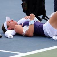 Britain's Johanna Konta receives medical attention after collapsing during her match against Bulgaria's Tsvetana Pironkova on Wednesday at the U.S. Open. Konta recovered to win 6-2, 5-7, 6-2. Raonic ousted by qualifier in 2nd round