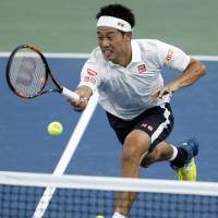 Kei Nishikori hits a return during his third-round match against Nicolas Mahut during the U.S. Open on Saturday In New York. Nishikori tops Mahut to reach fourth round