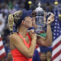 Germany's Angelique Kerber kisses the U.S. Open trophy after beating Karolina Pliskova of the Czech Republic in Saturday's final in New York. Kerber beats Pliskova to win U.S. Open title