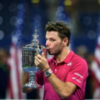 Stan Wawrinka kisses the trophy after his win over Novak Djokovic in the U.S. Open final on Sunday in New York. Wawrinka captures first U.S. Open title