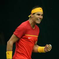Spain’s Rafael Nadal celebrates a point during his Davis Cup World Group playoff doubles match against India with partner Feliciano Lopez on Saturday. Nadal helps Spain get back to Davis Cup elite