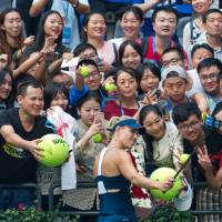 Angelique Kerber poses for a selfie with fans after playing against Kristina Mladenovic at the Wuhan Open in Wuhan, China, on Tuesday. Kerber survives first test as world No. 1
