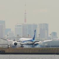 A Boeing 787 Dreamliner flown by All Nippon Airways lands at Haneda airport in Tokyo. Dreamliner strategy hit and miss for ANA