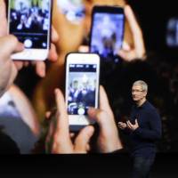 Apple CEO Tim Cook announces S. 7 the new iPhone 7 during an event to announce new products, in San Francisco. Apple reported Tuesday that it sold 45.5 million iPhones in the previous quarter, 5 percent fewer than it sold a year earlier. But the giant tech company’s rosy forecast for the holidays was better than what Wall Street had been expecting. Apple quarterly profit off 19% as iPhone sales slip but Cook upbeat