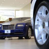 Rolls-Royce Motor Cars Ltd. cars stand on display inside a showroom in Tokyo. Uptick in luxury car sales a bright spot amid retail lull