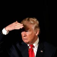 Republican presidential nominee Donald Trump listens to a question as he appears at the “Retired American Warriors” conference during a campaign stop in Herndon, Virginia, Monday. New York attorney general orders unregistered Trump Foundation to stop fundraising