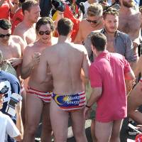 Australian spectators in swimwear bearing a Malaysian flag party during the F1 Malaysian Grand Prix on Sunday. Aussies accused of premeditated Budgy Smuggler briefs display at Malaysia F1 race