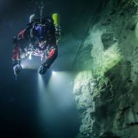 Polish explorer Krzysztof Starnawski examines the limestone crevasse in the Czech Republic's flooded Hranicka Propast, or Hranice Abyss, on Aug. 21, 2015, ahead of an expedition to measure its depths. World's deepest underwater cave found in the Czech Republic