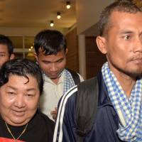 Cambodian seafarers released after being held hostage by Somali pirates are surrounded by media after arriving at Phnom Penh International Airport on Sunday. The seafarers are among 26 hostages freed from the crew of Naham 3 seized south of the Seychelles in March 2012. Cambodian fishermen home, recount horrors of five-year hostage ordeal