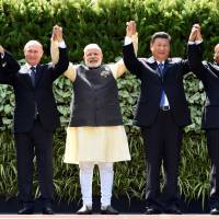 Brazilian President Michel Temer, Russian President Vladimir Putin, Indian Prime Minister Narendra Modi, Chinese President Xi Jinping and South African President Jacob Zuma raise their hands during a group photo at the BRICS summit in Goa on Sunday. At BRICS summit, Modi accuses Pakistan of being 'mother-ship of terrorism'