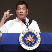 Philippine President Rodrigo Duterte delivers a speech at the Philippine Economic Forum in Tokyo on Wednesday. Duterte vows not to abandon Japan on security matters as he takes more jabs as U.S.