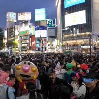 A large crowd of revelers mill about in Hachiko Square in front of JR Shibuya Station in Tokyo on Oct. 31, 2015. Shibuya readies for Halloween party throngs