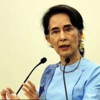 Myanmar leader Aung San Suu Kyi speaks at a meeting in the administrative capital of Naypyitaw on Oct. 22. Suu Kyi may overlook qualms with Japan, give firms chance to move in: experts