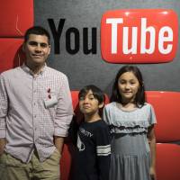Where we’re headed: Greg Lam poses for a picture with his two children, Shintaro and Aiko, at YouTube’s main offices in Tokyo. The Canadian videographer runs a channel on the video-streaming website that aims to show kids in other parts of the world what life is like in Japan. YouTube channel Life Where I'm From explores Japan from a kid's perspective