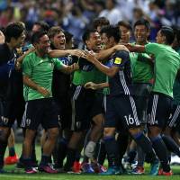 Japan players congratulate Hotaru Yamaguchi (16) after his 95th-minute goal secured a 2-1 World Cup-qualifying win over Iraq at Saitama Stadium on Thursday. Halilhodzic toasts Japan after dramatic win over Iraq