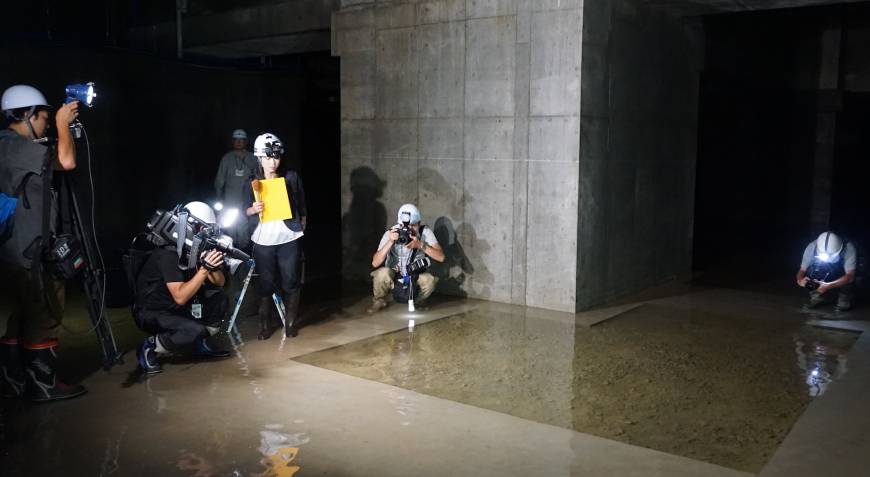 Reporters investigate ground water in the basement of the new Toyosu produce market in September.