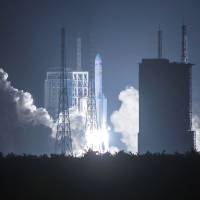 China’s heavy-lift Long March-5 rocket blasts off from its launch center in Wenchang, in southern China’s Hainan province, on Thursday. China boosts space program with new heavy rocket's launch