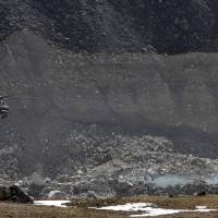 A helicopter carrying Cabinet ministers of Nepal flies past a glacial lake in Kalapathar, a flat area at an altitude of 17,192 feet (5,250 meters) next to Everest base camp, in 2009. Army soldiers and local villagers have finished digging through rocks and boulders to drain another glacial lake just south of Mount Everest, bringing the water to a safe level and possibly preventing an outburst that could have flooded several villages, officials said Tuesday. Amid global warming, Nepal drains dangerous, fast-growing glacial lake near Everest