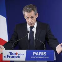 Nicolas Sarkozy, former French president and candidate for the French conservative presidential primary, reacts after partial results in the first round of the French center-right presidential primary election at his campaign headquarters in Paris Sunday. Sarkozy knocked out of French presidential race in surprise upset