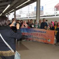 Indonesian tourists pose for a photo at Mikawa-Anjo Station on the Tokaido Shinkansen Line. Mikawa-Anjo Station offers foreign visitors brief, cheap shinkansen experience