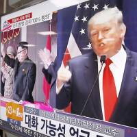 Asian insecurity: A TV screen at a railway station in Seoul shows pictures of U.S. President-elect Donald Trump and North Korean leader Kim Jong Un. Trump, Putin and Kim make Abe miserable